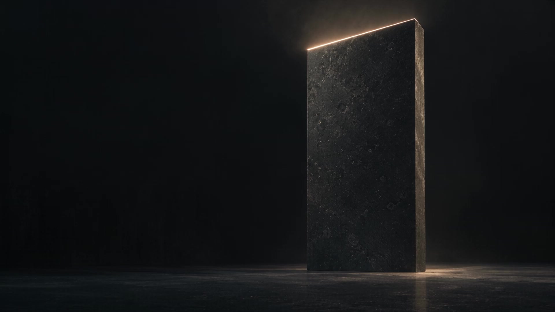 A monumental black limestone slab edged with warm light